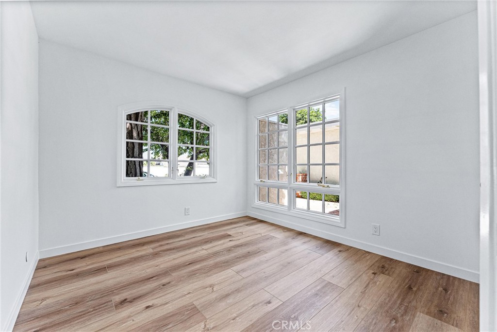 29 Bethany Drive Irvine, CA 92603 - Photo 26 of 44 an empty room with wooden floor and windows