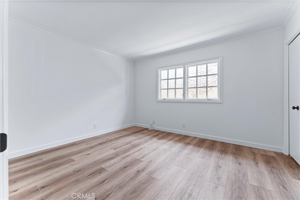 29 Bethany Drive Irvine, CA 92603 - Photo 28 of 44 an empty room with wooden floor and windows