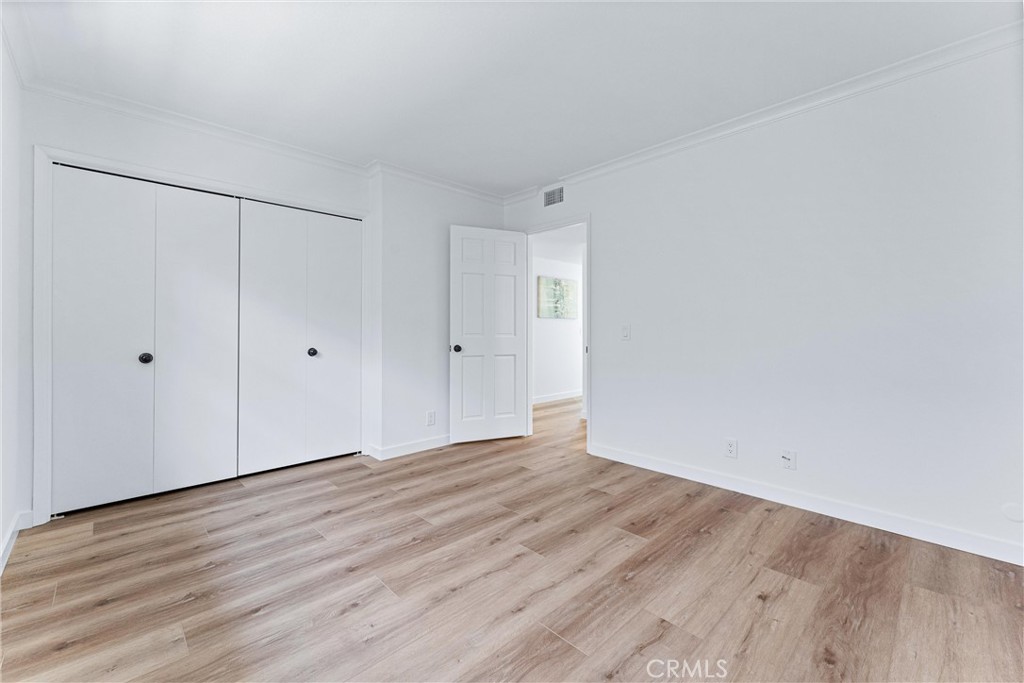 29 Bethany Drive Irvine, CA 92603 - Photo 29 of 44 a view of an empty room with wooden floor