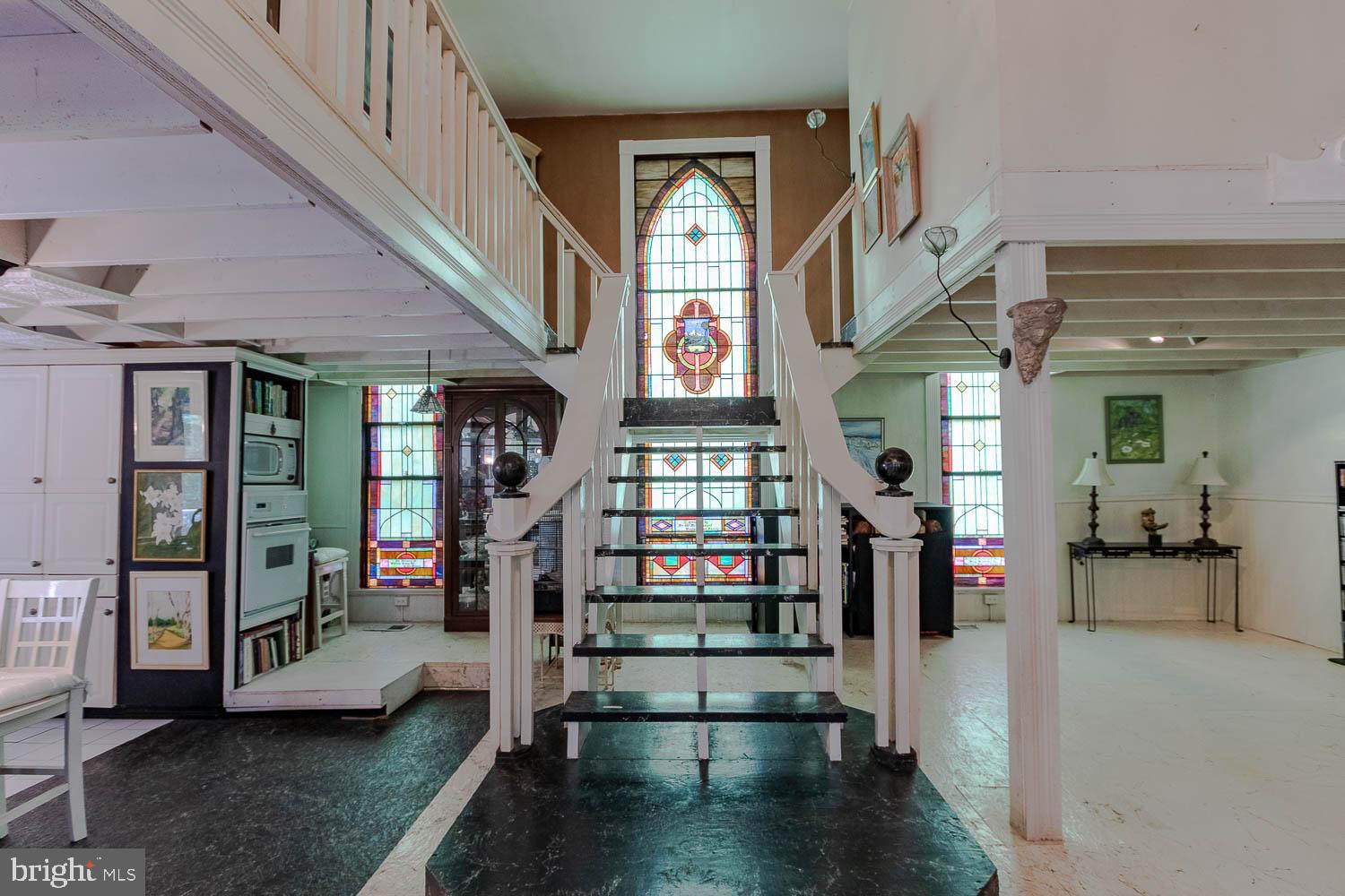 a view of hall way with furniture