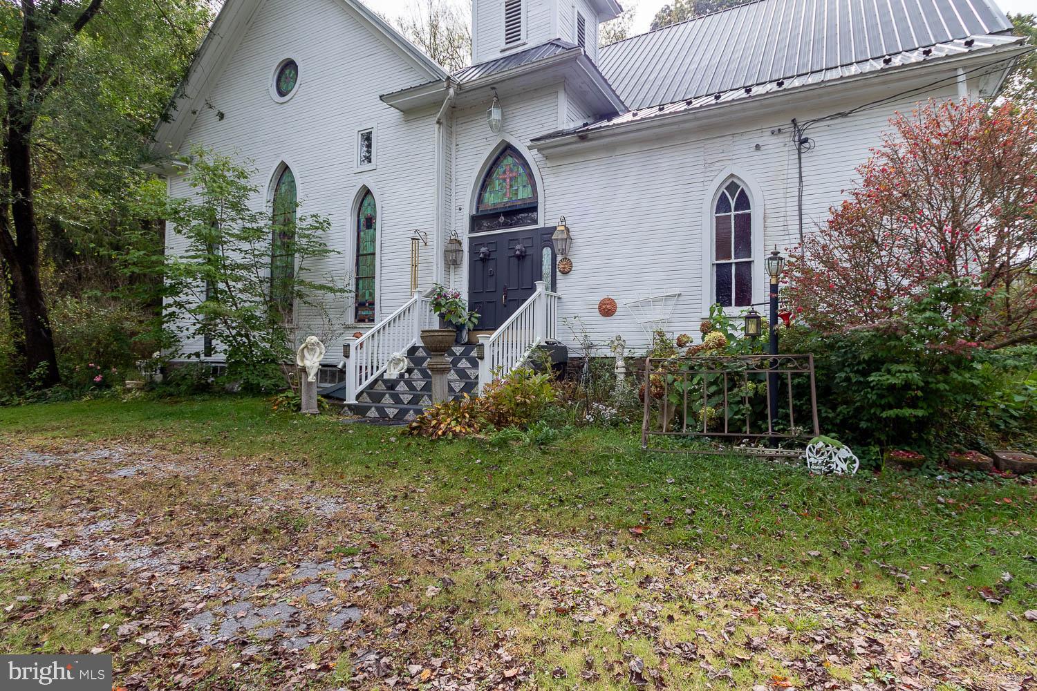 125 Colorado Road Munson, PA 16860 - Photo 2 of 43 a front view of a house with garden