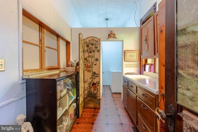a bathroom with a granite countertop double vanity and a bathtub