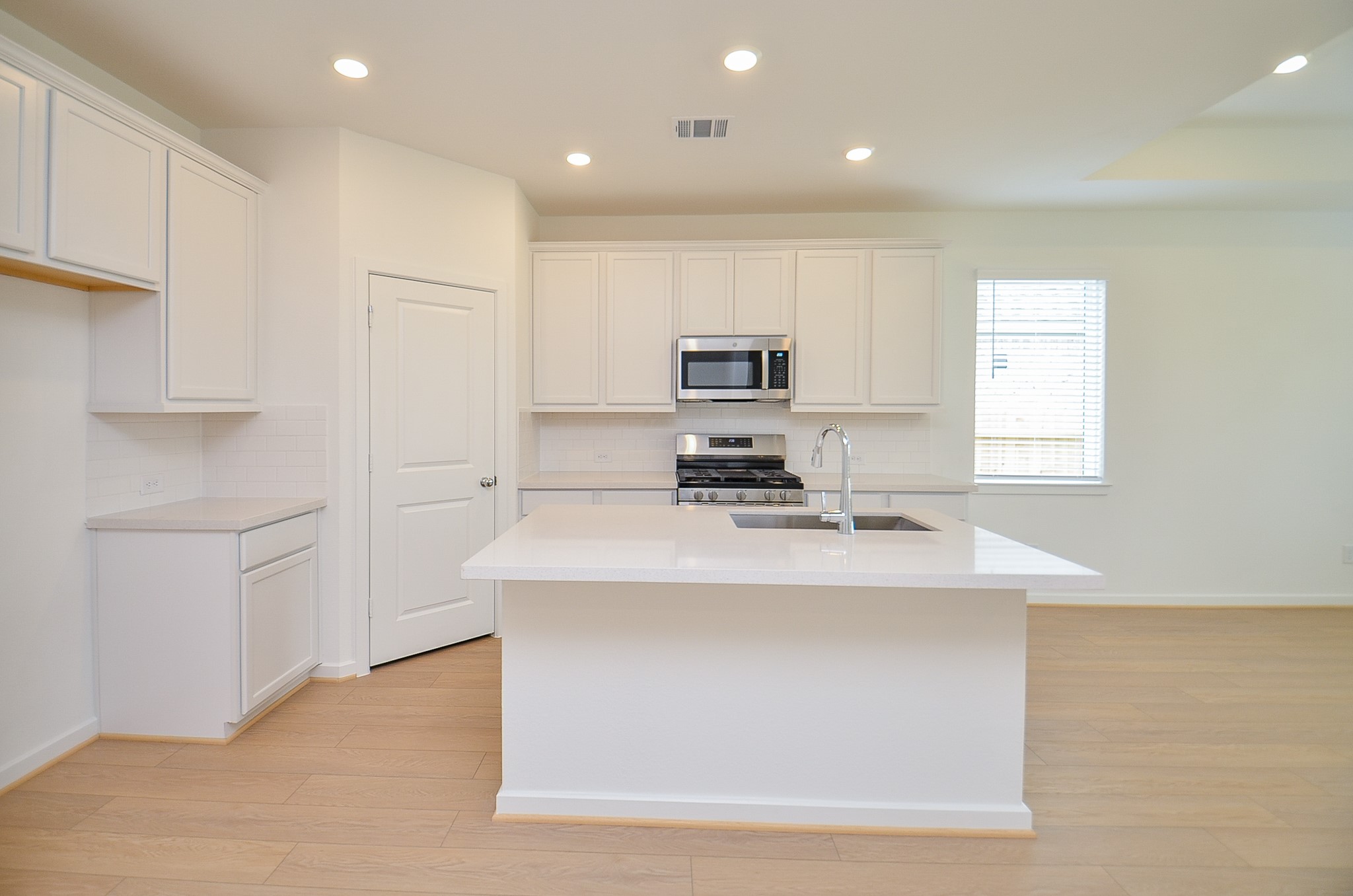 9727 Rialto Hts Drive Cypress, TX 77433 - Photo 11 of 37 Bright, open room with light color flooring, recessed lighting, and a door leading to the outside. The space is versatile and well-lit, ideal for personalization.