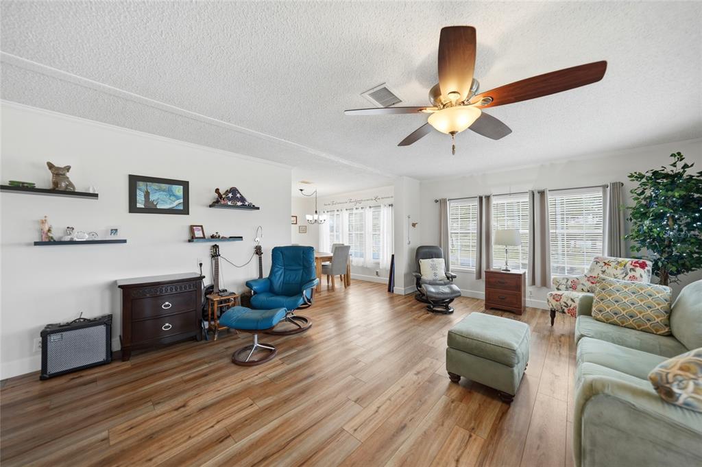 10303 Burnt Store Road, Unit 143 Punta Gorda, FL 33950 - Photo 10 of 42 a living room with furniture and a wooden floor