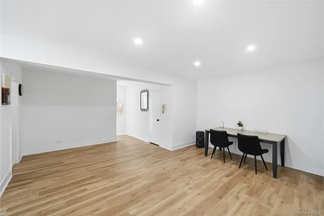 a view of a workspace with wooden floor