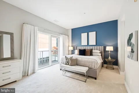 a bedroom with a bed and large window