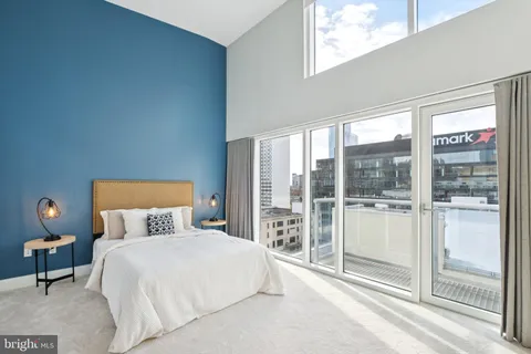 a bedroom with a large bed and a night stand