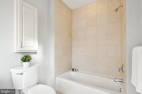 a bath room with a toilet and a bath tub