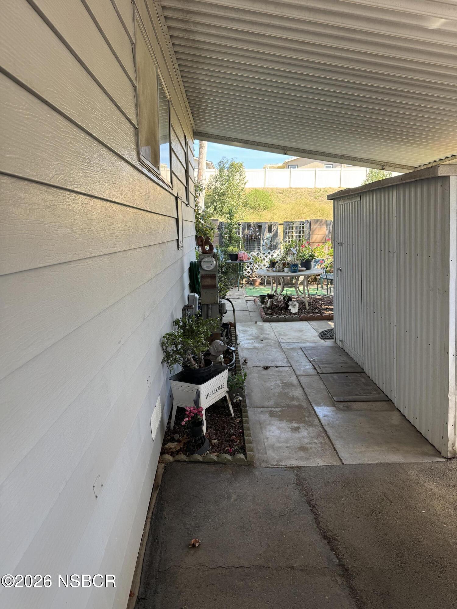 3210 Santa Maria Way, Unit 173 Santa Maria, CA 93455 - Photo 19 of 24 a view of a patio with table and chairs and potted plants