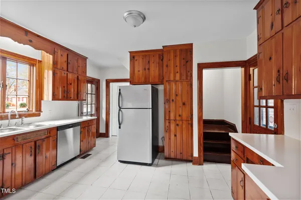 a kitchen with a refrigerator and a stove