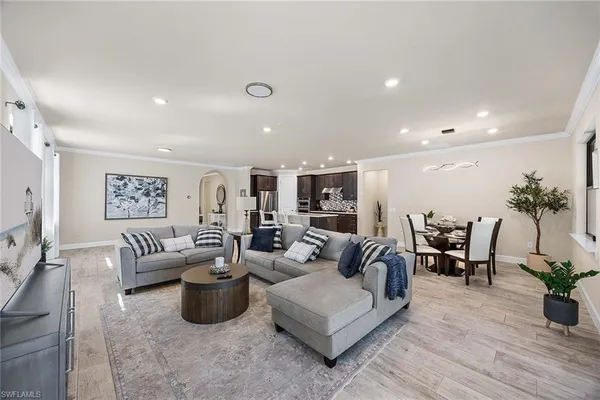 a living room with furniture potted plant and couches