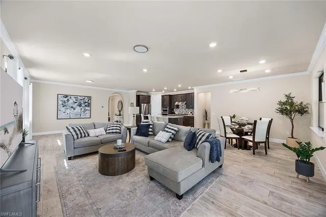 a living room with furniture potted plant and couches