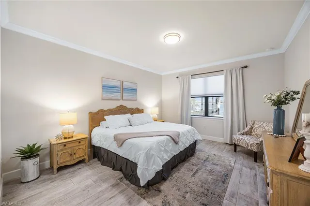 a bedroom with a bed and potted plant