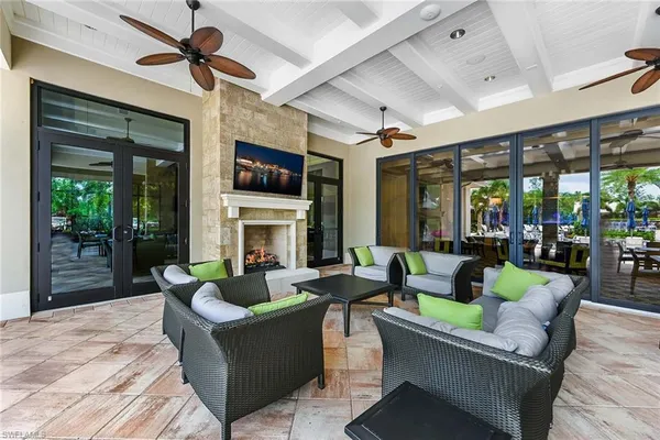 a living room with fireplace furniture and a large window