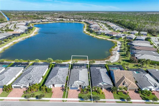 an aerial view of a residential building and lake view
