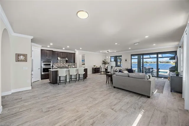 a living room with furniture and kitchen view