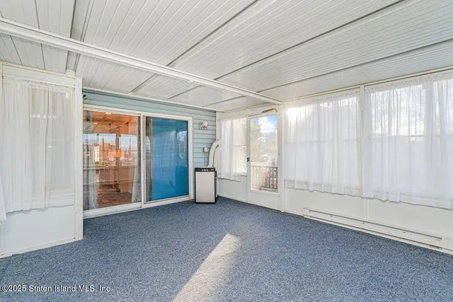 a view of front door with wooden floor and stairs