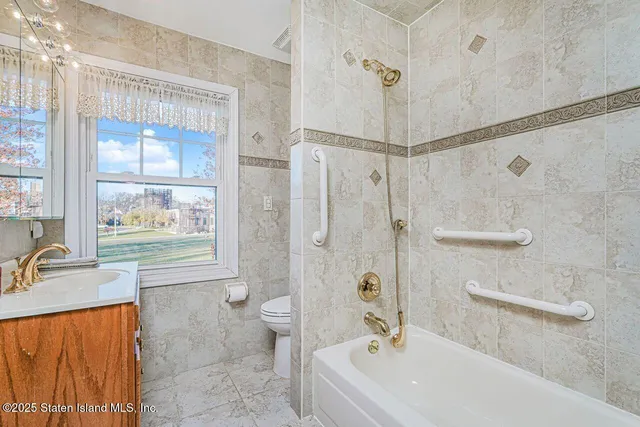 a bathroom with a granite countertop sink a mirror and a shower