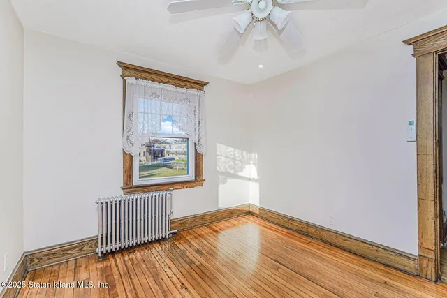 an empty room with a ceiling fan