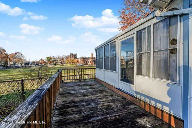 a view of a house with a yard and potted plants