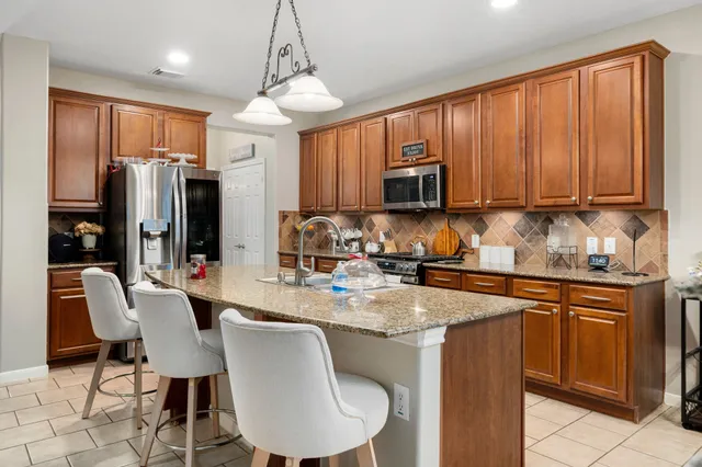 a kitchen with refrigerator cabinets dining table and chairs