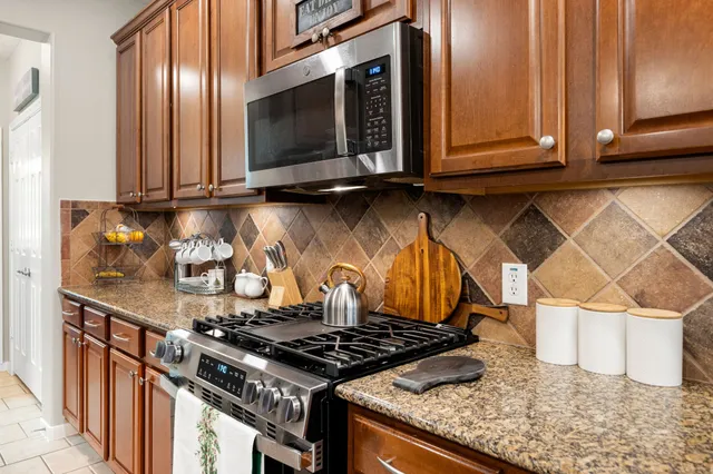 a stove top oven sitting inside of a kitchen