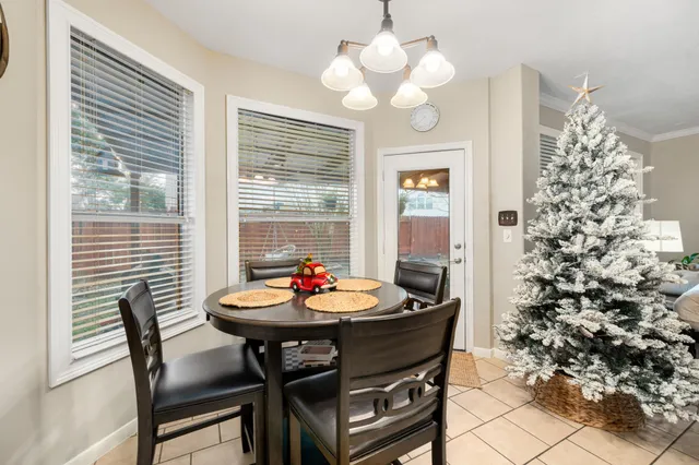 a view of a dining room with furniture and chandelier