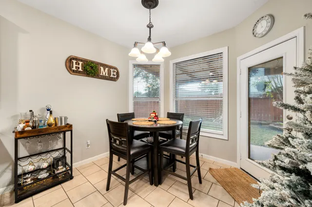 a dining room with furniture and window