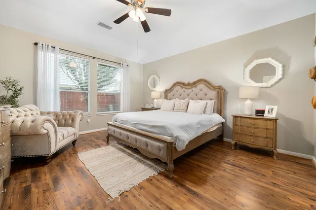 a bedroom with a bed and a large window