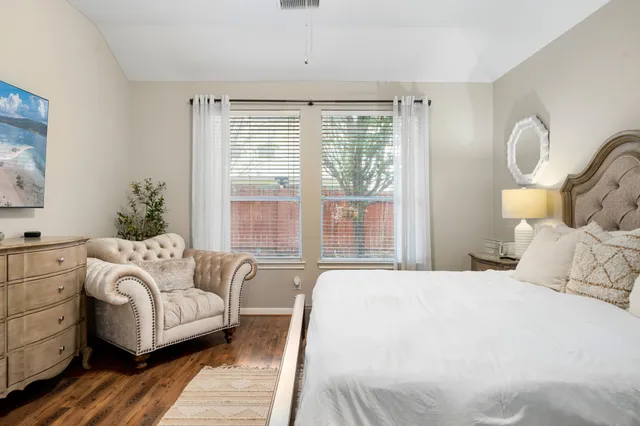 a bedroom with bed and wooden floor