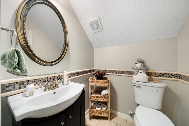 a bathroom with a sink mirror and toilet