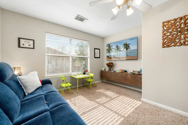 a living room with furniture and a large window