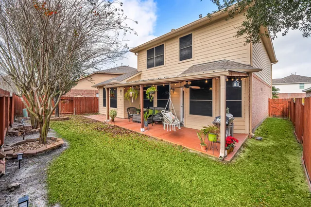 a view of a house with a yard patio and swimming pool