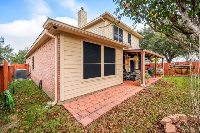 a view of a house with backyard and sitting area