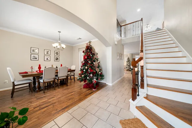 a very nice looking room with many windows and stairs