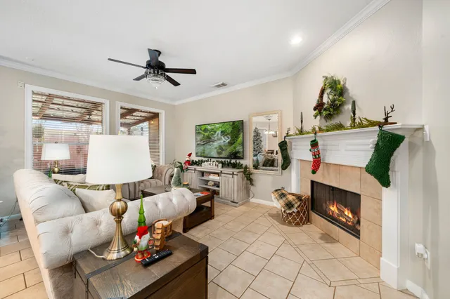 a living room with furniture a flat screen tv and a fireplace