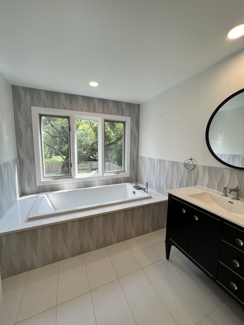 2535 Techny Road Northbrook, IL 60062 - Photo 16 of 30 a bathroom with a bathtub sink and mirror