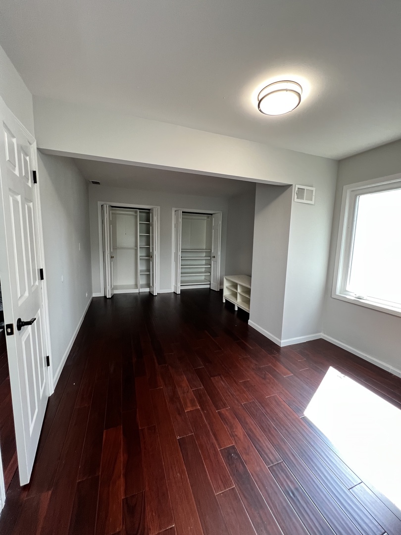 2535 Techny Road Northbrook, IL 60062 - Photo 21 of 30 a view of empty room with wooden floor and fan