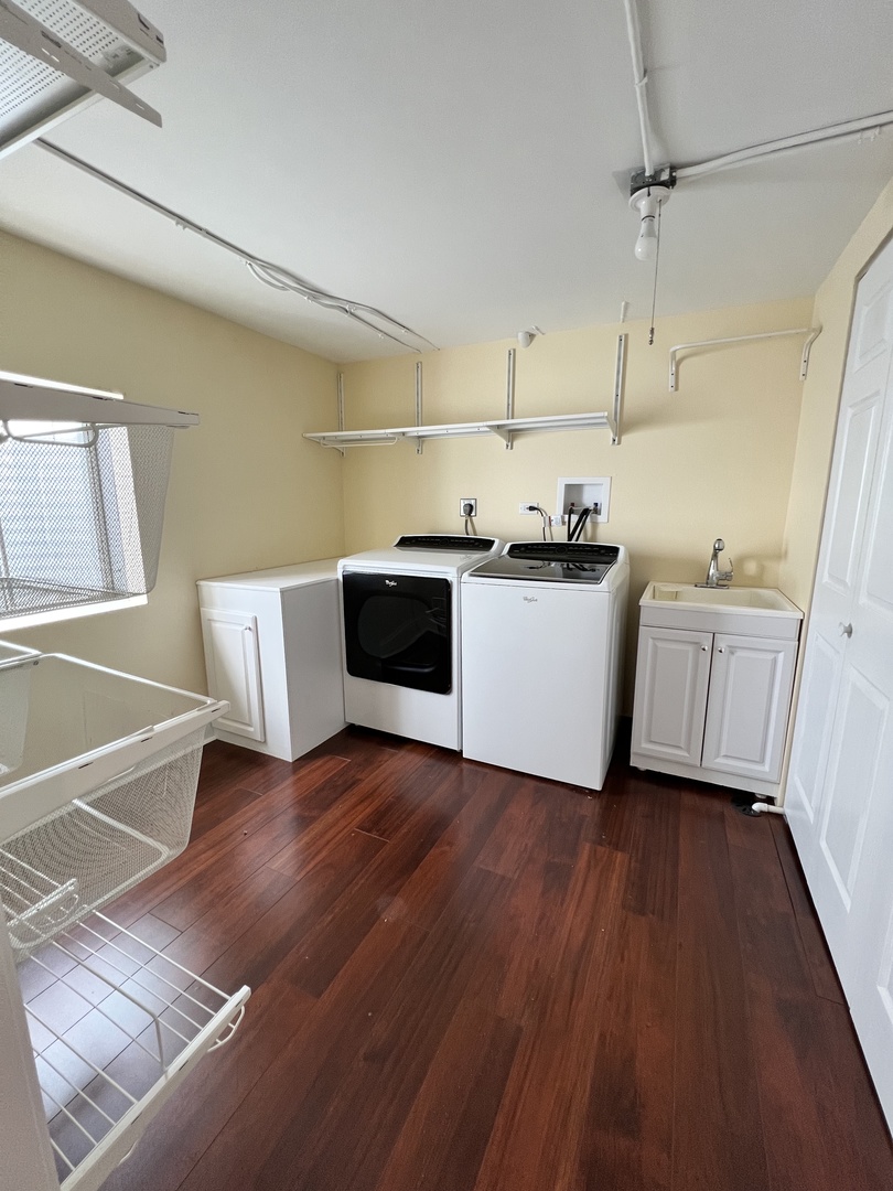 2535 Techny Road Northbrook, IL 60062 - Photo 24 of 30 a kitchen with wooden floors and white cabinets