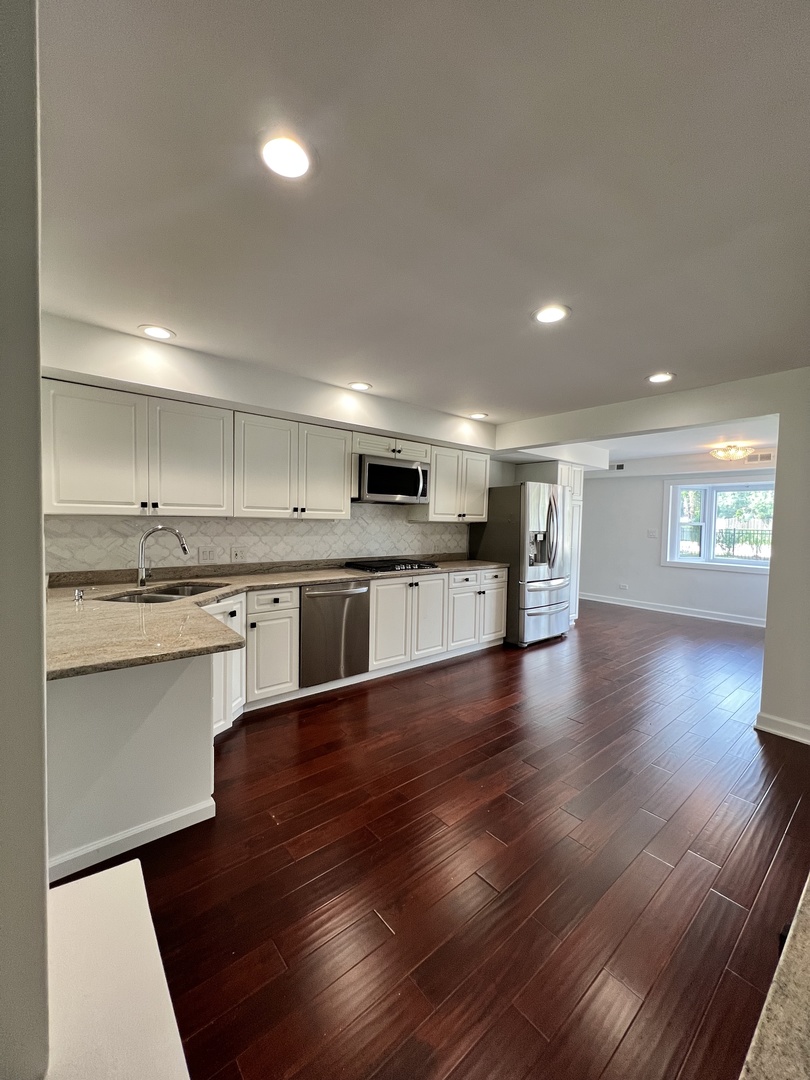 2535 Techny Road Northbrook, IL 60062 - Photo 3 of 30 a large kitchen with stainless steel appliances granite countertop a large counter top a sink and a stove