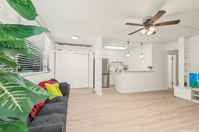 a living room with kitchen appliances and furniture