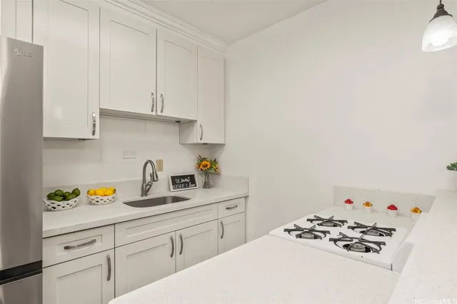 a kitchen with a sink a stove and cabinets