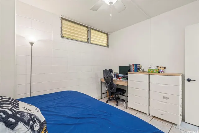 a bedroom with a bed and a workspace