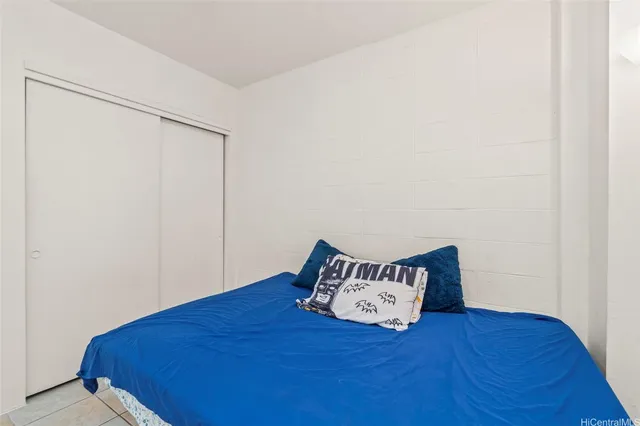 a bedroom with a bed and a night stand