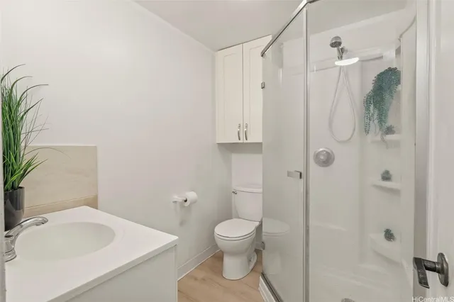 a bathroom with a toilet sink and shower