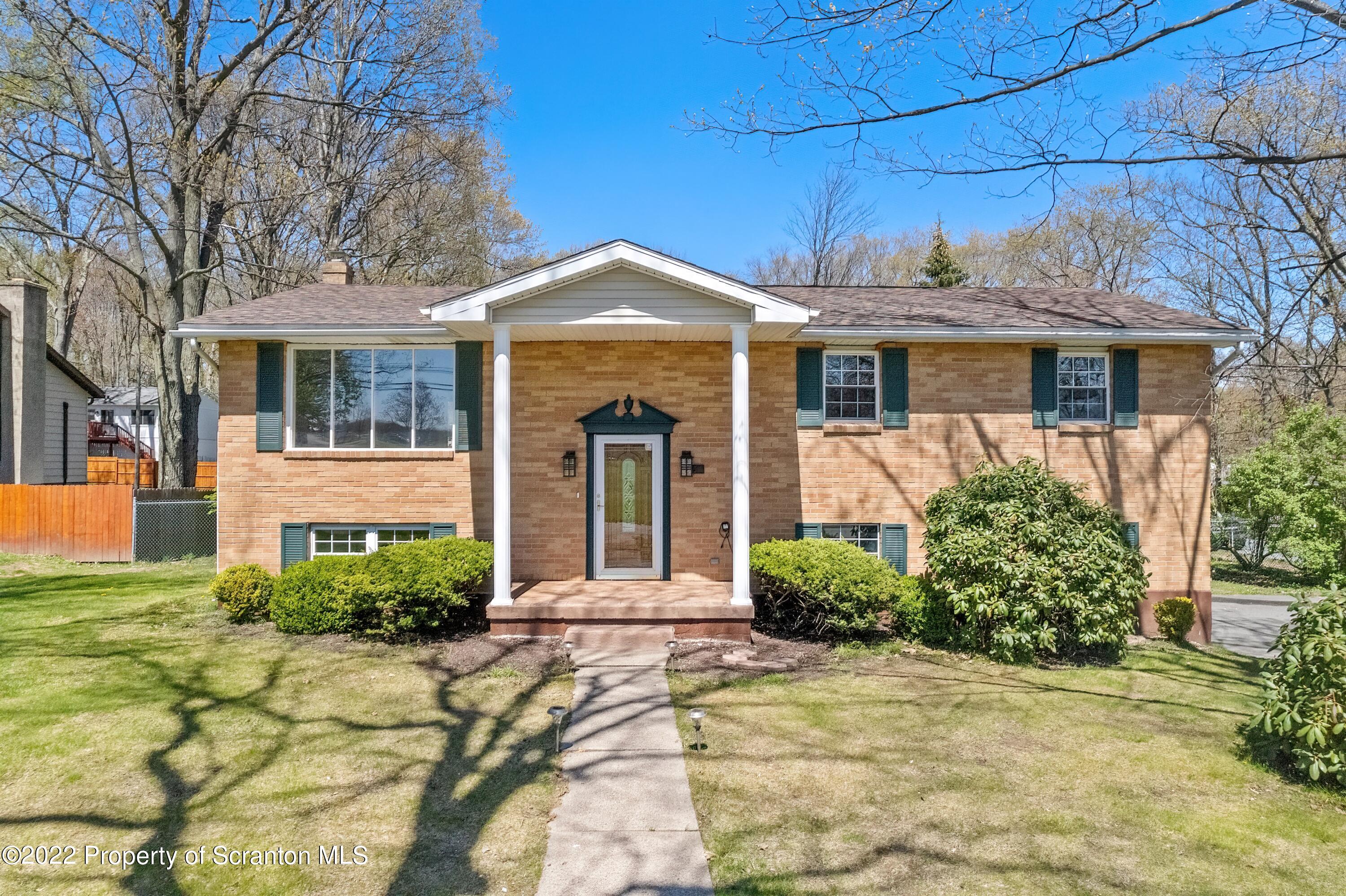 219 Noble Road Clarks Summit, PA 18411 - Photo 1 of 33 a front view of a house with garden