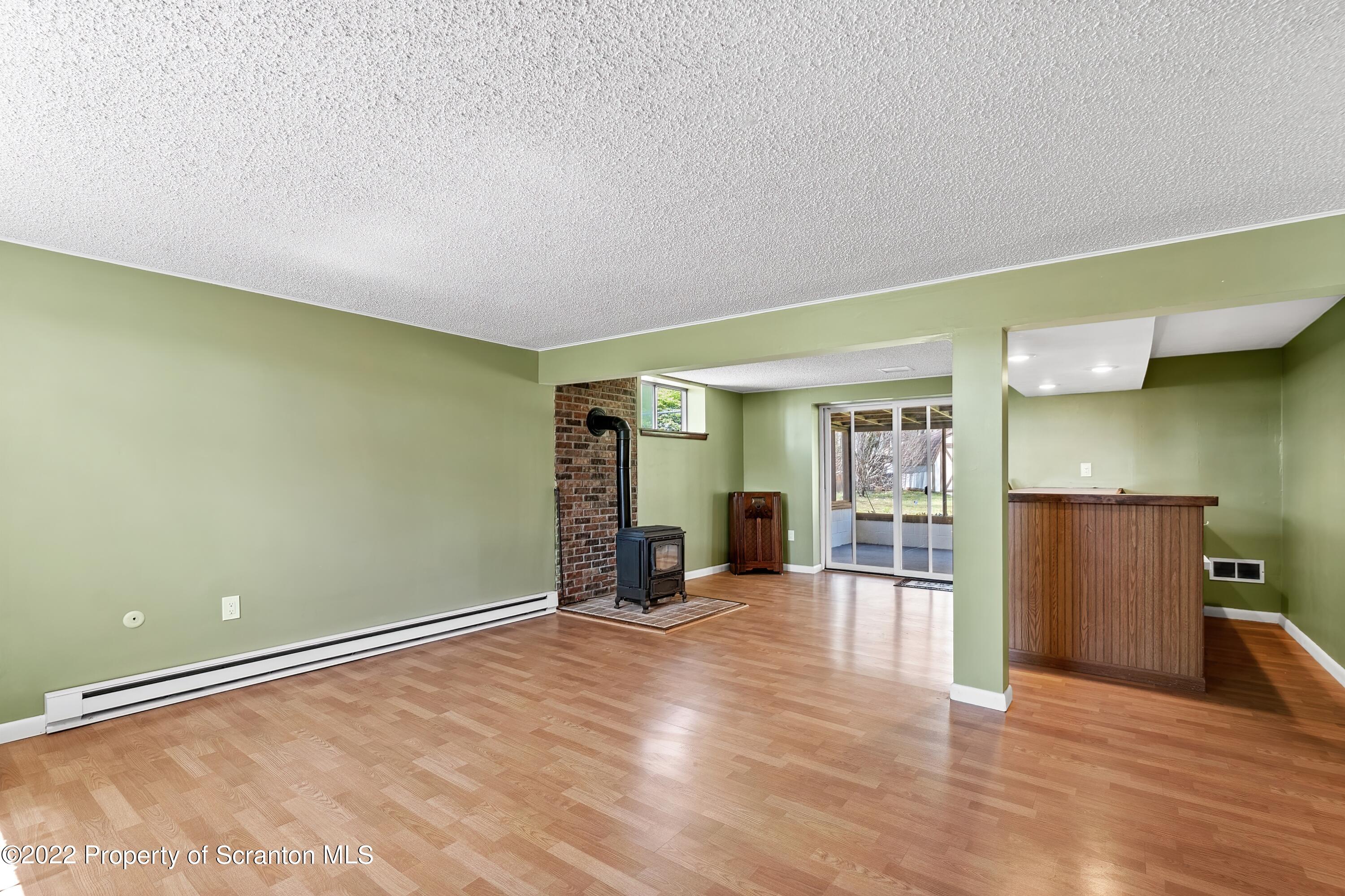 219 Noble Road Clarks Summit, PA 18411 - Photo 20 of 33 a view of an empty room with wooden floor and a window