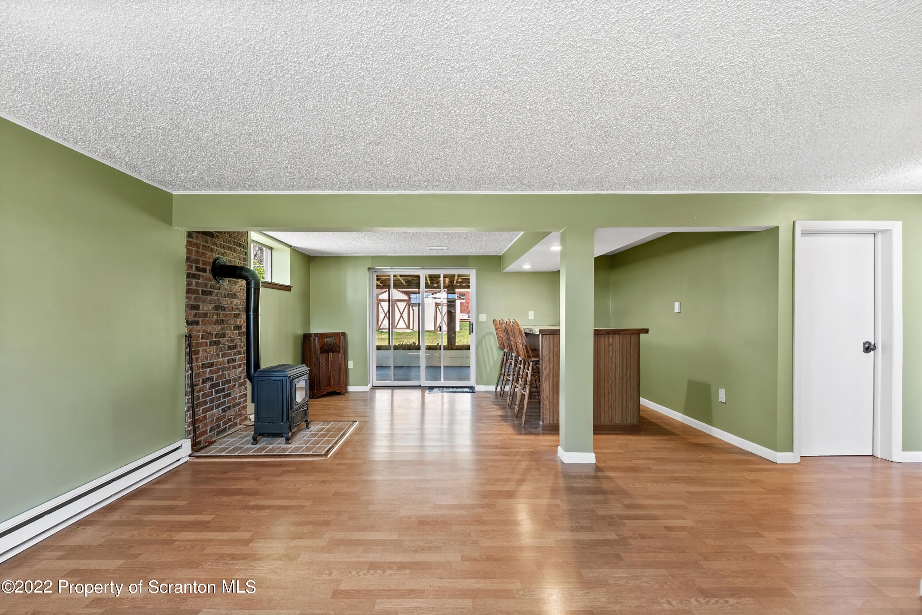219 Noble Road Clarks Summit, PA 18411 - Photo 21 of 33 wooden floor in an empty room with a fireplace