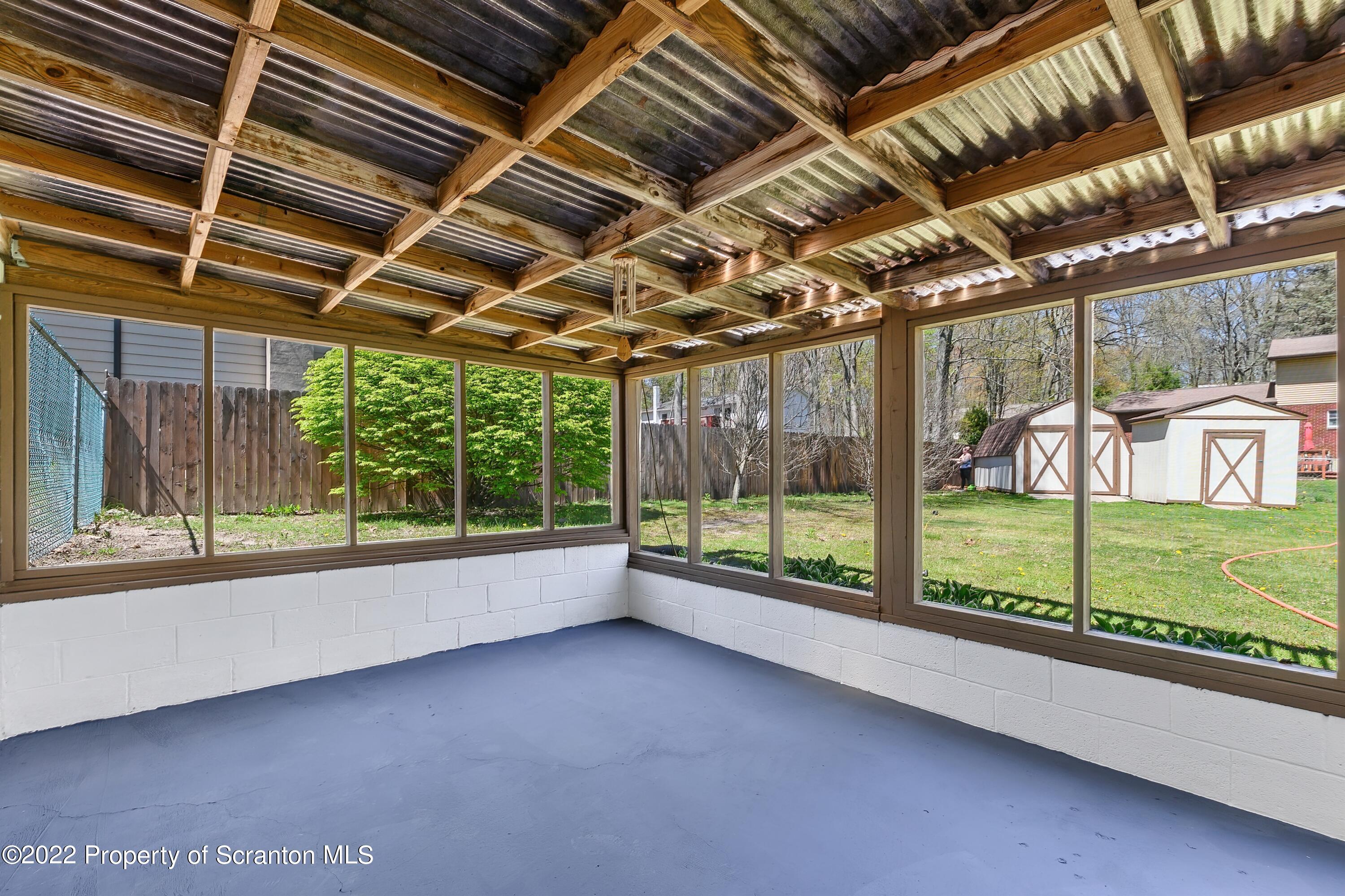 219 Noble Road Clarks Summit, PA 18411 - Photo 26 of 33 a view of a room with large windows and a table