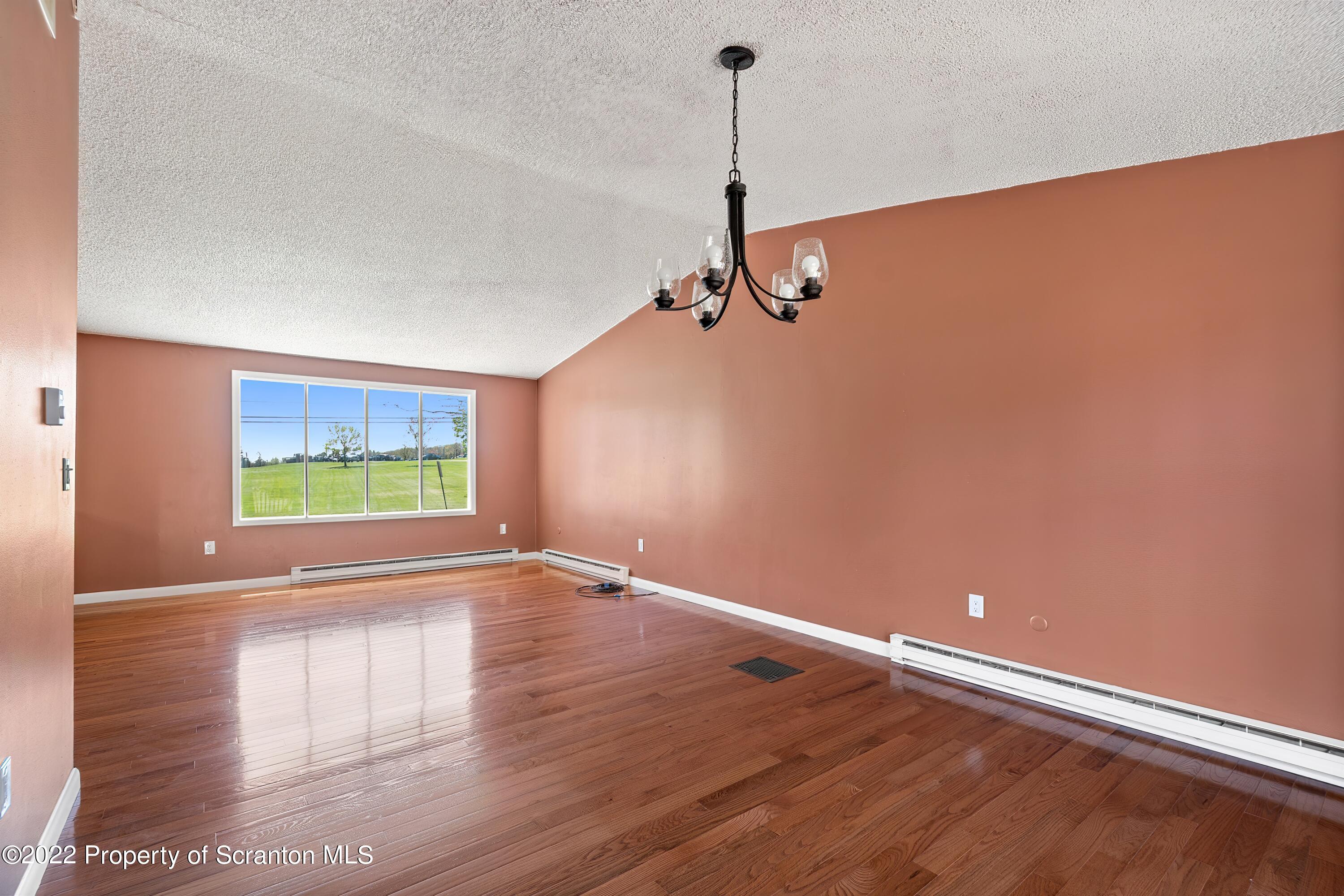 219 Noble Road Clarks Summit, PA 18411 - Photo 4 of 33 a view of an empty room with wooden floor and a window